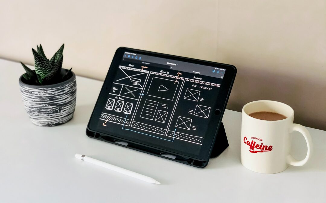 tablet set up on table showing website design plans